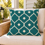 Teal Moroccan lantern outdoor pillow on a rattan chair on a sunny summer porch
