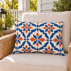 Moroccan Tile Terracotta Blue outdoor lumbar pillow on a rattan chair on a sunny summer porch