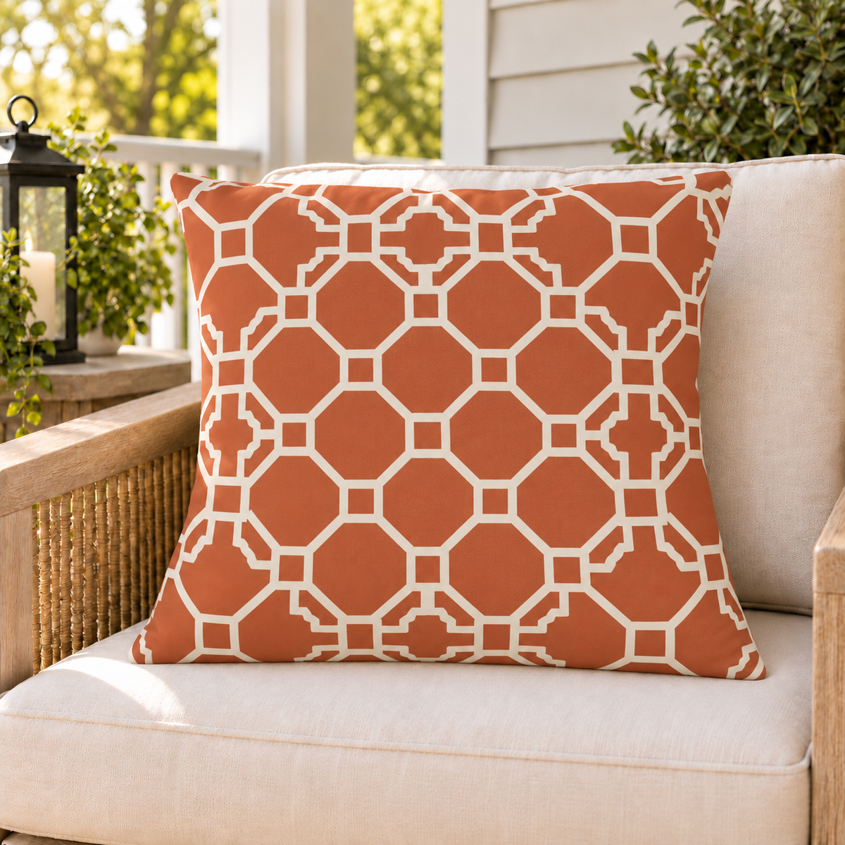 Moroccan Trellis Terracotta outdoor pillow on a rattan chair on a sunny summer porch