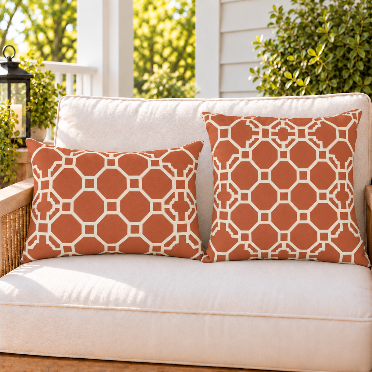 Moroccan Trellis Terracotta outdoor pillow and outdoor lumbar pillow styled together as a set on a porch loveseat