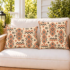 Terracotta mudcloth boho outdoor pillow and outdoor lumbar pillow styled together as a set on a porch loveseat