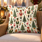 Cream nutcracker and trees outdoor pillow on a rattan chair on a Christmas porch