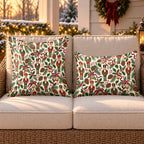 Ivory nutcracker and holly outdoor pillow and outdoor lumbar pillow styled together as a set on a wicker loveseat for Christmas