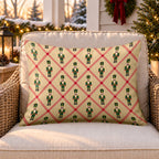 Tan lattice nutcracker outdoor lumbar pillow on a rattan chair on a Christmas porch