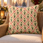 Tan lattice nutcracker outdoor pillow on a rattan chair on a Christmas porch