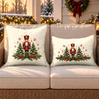 Cream nutcracker and pines outdoor pillow and outdoor lumbar pillow styled together as a set on a wicker loveseat for Christmas