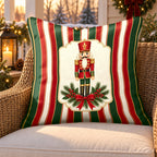 Red stripe nutcracker outdoor pillow on a rattan chair on a Christmas porch