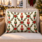 Cream nutcracker trellis outdoor lumbar pillow on a rattan chair on a Christmas porch