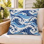 Navy ocean wave outdoor pillow on a rattan chair on a sunny summer porch
