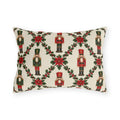 Christmas nutcracker outdoor lumbar pillow with a holly trellis, poinsettias and red and green nutcracker soldiers on cream