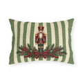 Sage green Christmas nutcracker outdoor lumbar pillow with a nutcracker, pine and a burgundy ribbon on sage and cream stripes