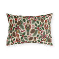 Vintage Christmas nutcracker outdoor lumbar pillow with nutcrackers, pine, pinecones, holly and burgundy ribbon on ivory