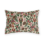 Vintage Christmas nutcracker outdoor lumbar pillow with nutcrackers, pine, pinecones, holly and burgundy ribbon on ivory