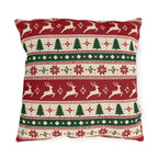 Nordic Christmas reindeer outdoor pillow with graphic bands of reindeer, pine trees and snowflakes in red, green and cream