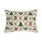 Christmas village outdoor lumbar pillow with a green lattice of pine trees, holly, mittens, gifts and cottages on cream