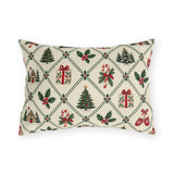 Christmas village outdoor lumbar pillow with a green lattice of pine trees, holly, mittens, gifts and cottages on cream