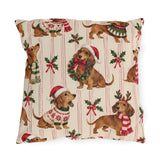 Christmas dachshund outdoor pillow with dachshunds in Santa hats, scarves and sweaters among holly on cream