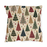 Christmas tree outdoor pillow with a scatter of red, green, navy and tan Christmas trees and gold stars on cream