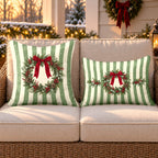 Sage stripe wreath outdoor pillow and outdoor lumbar pillow styled together as a set on a wicker loveseat for Christmas