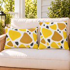 Yellow terrazzo outdoor pillow and outdoor lumbar pillow styled together as a set on a porch loveseat