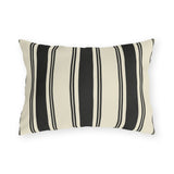 Black and cream ticking stripe outdoor lumbar pillow with bold and thin vertical black stripes
