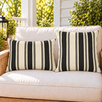Black and cream ticking stripe outdoor pillow and outdoor lumbar pillow styled together as a set on a porch loveseat